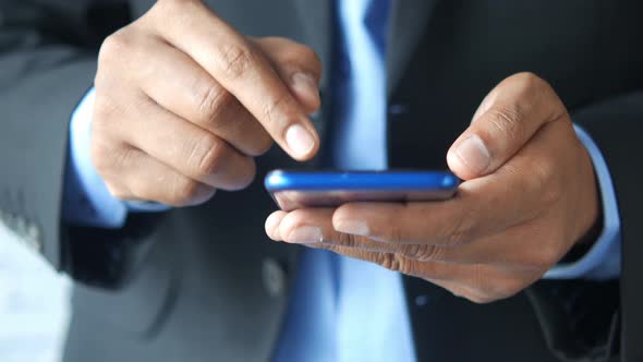 Close Up of Young Man Hand Using Smart Phone