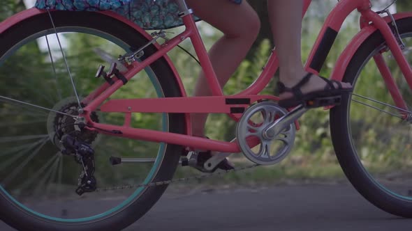 Cyclist Legs Girl Workout Riding On Bicycle In Summer Dress. Cycling In Sunset City Park. Have Fun.