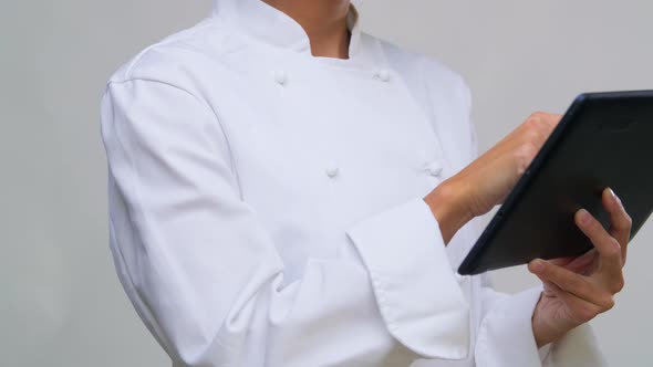 Female Chef in Toque with Tablet Computer