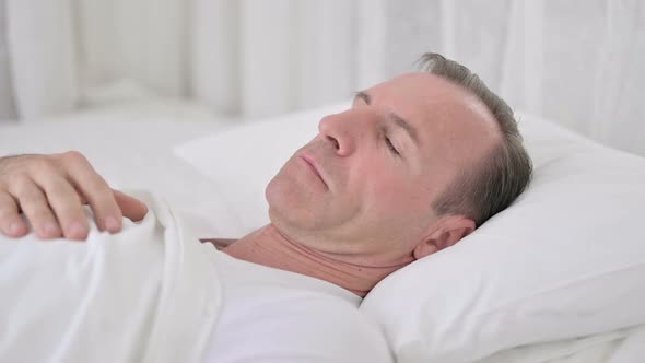 Comfortable Middle Aged Man Sleeping in Bed