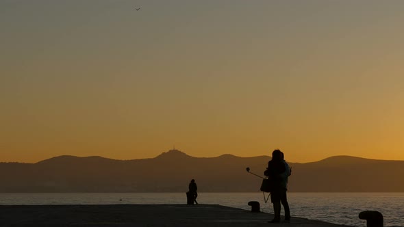 Couple taking a selfie by the water