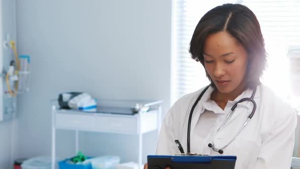 Male and female doctor discussing over x-ray report