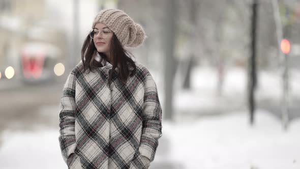 Thoughtful Teen Girl Is Walking Alone at Winter City Medium Portrait in Movement