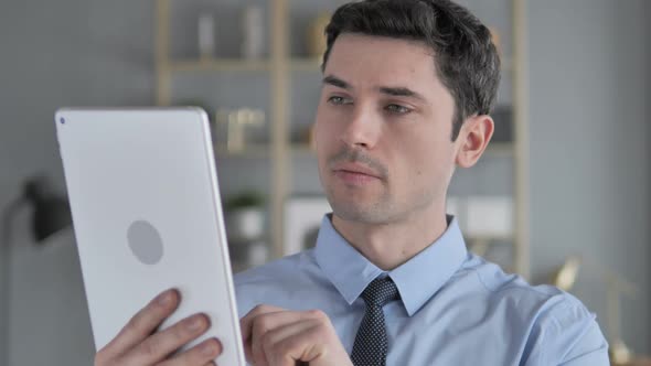 Young Man Using Tablet at Workplace