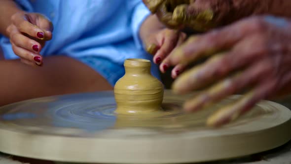 Closeup Girl Hands Make Clay Vase Neck on Potter Wheel
