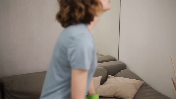 Enfeebled Young Woman Falling Down on a Couch After Cleaning Feeling Tired After Washing Wooden