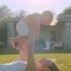 Happy Young Mom Holding Cute Adorable Infant Child Boy Lifting Up in Hands - VideoHive Item for Sale