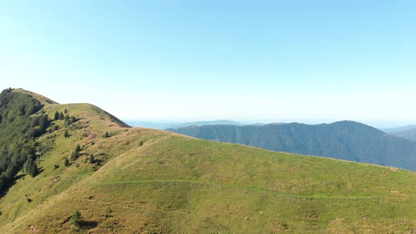 Mountain pasture at top of mountain. Ridge in Slovenia used for grazing livestock. Aerial footage, S