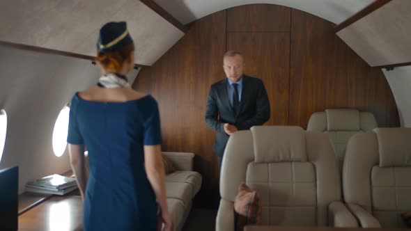Stewardess Helping Passengers Inside of Air Jet