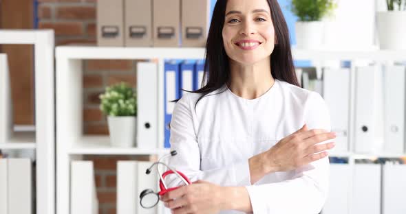 Portrait of Smiling Young Female Doctor Holding Stethoscope