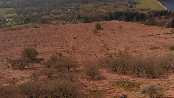 Drone travelling towards a Peak in the Peak District while panning up from Bamford Edge shot in 4K