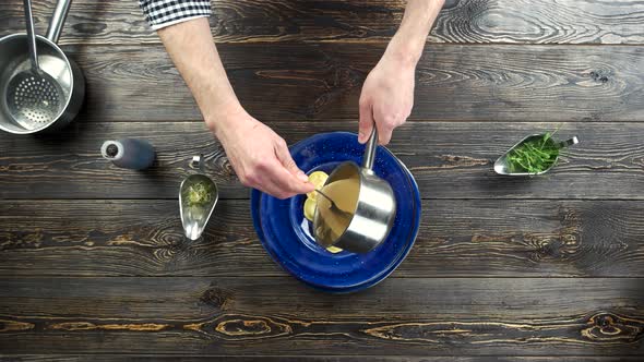 Chef Pouring Sauce on Ravioli.