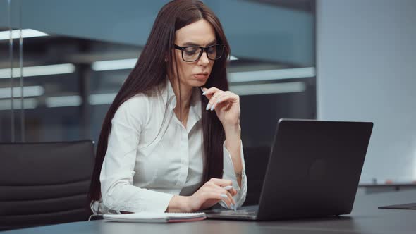 Businesswoman Financial Analyst Using Laptop in Office