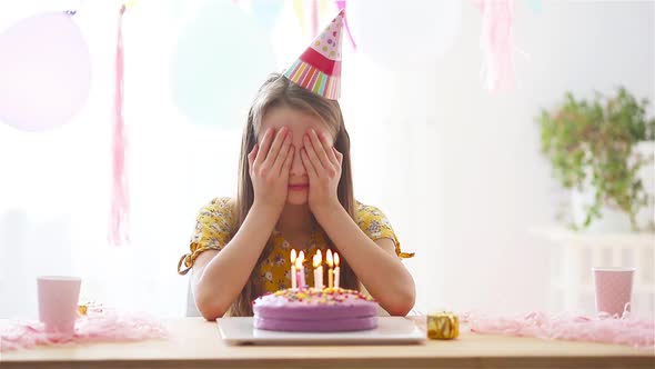 Caucasian Girl Is Dreamily Smiling and Looking at Birthday Rainbow Cake. Festive Colorful Background