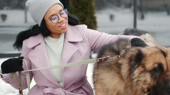 Woman Walking Cute Dog Outdoors on Winter Day