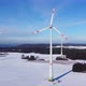 Flying towards a windfarm. Aerial view of wind turbines on a snowy field in Germany. - VideoHive Item for Sale