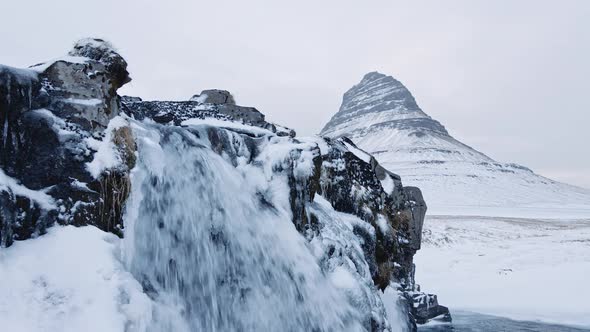 Drone Of Waterfalls And Frozen Landscape With Kirkjufell Mountain