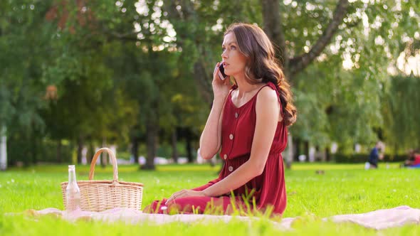 Woman Calling on Smartphone on Picnic at Park