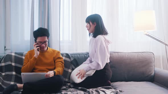 Young Woman Seeking Attention of Her Boyfriend Who is Working on Laptop