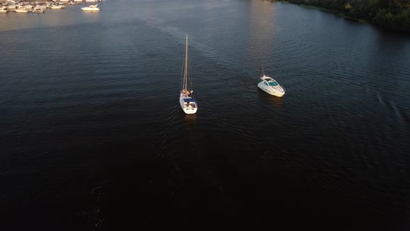 Aerial view of the modern sailboat sailing on the river