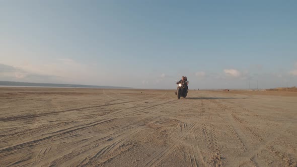 Guy with a Girl on a Motorcycle in the Desert