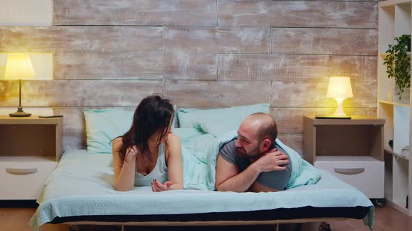 Zoom in Shot of Cheerful Couple Wearing Pajamas