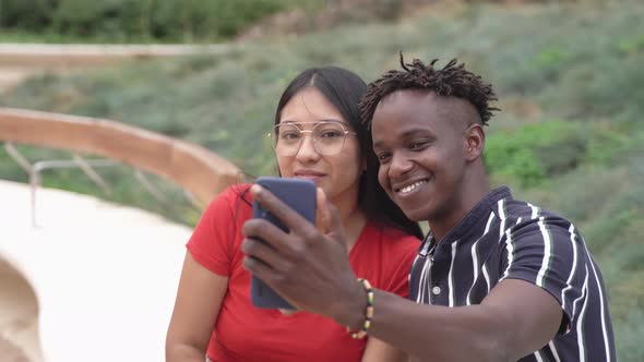 Multiracial Young Friends Having Fun Taking Selfie with Mobile Phone Outdoor