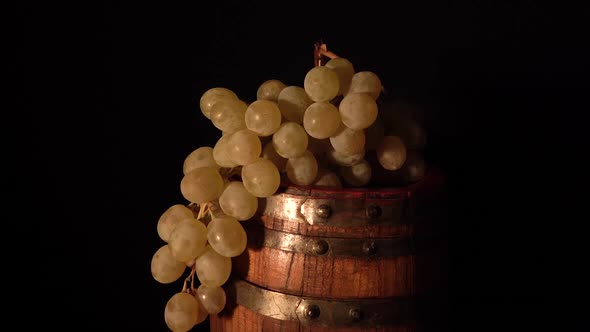 Closer view and backward rotating wine barrel with grape.