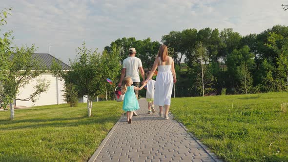 Back View of Family with Children Going to Have a Picnic and Have Fun Together