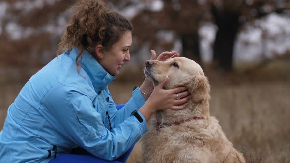 Positive Woman Bonding with Her Dog Outdoors