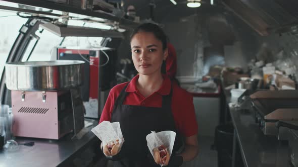 Portrait of Woman with Hot Dogs in Food Truck