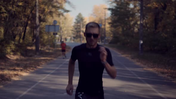 Runner Legs.Running In Forest. Athlete Professional Runner Jogging.Triathlete Ready For Marathon.