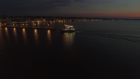 Flying over touristic ship finishing night sea tour