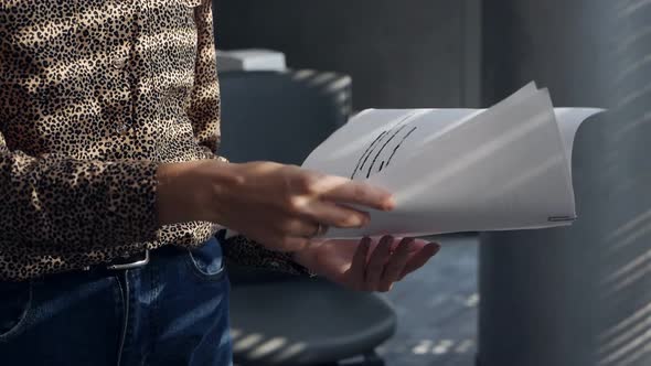 An Undercover Spy Examines Confidential Documents in the Office