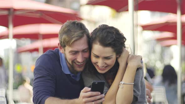 Couple laughing at content on smart phone