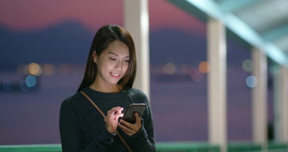 Woman use cellphone app at street