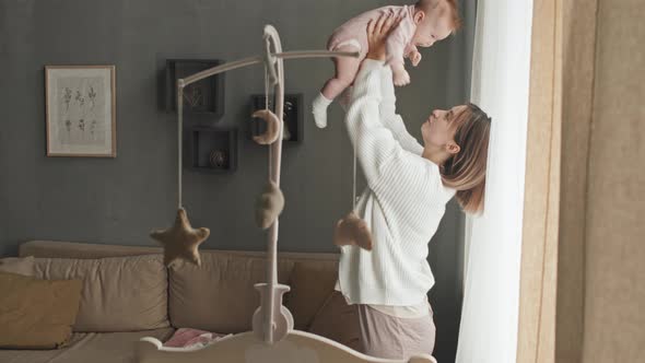 Woman Lifting Baby Daughter Up