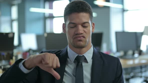 Portrait of African Businessman Showing Thumbs Down