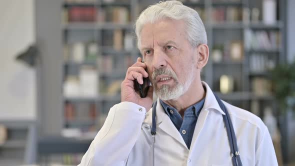 Senior Old Doctor Talking on Smartphone