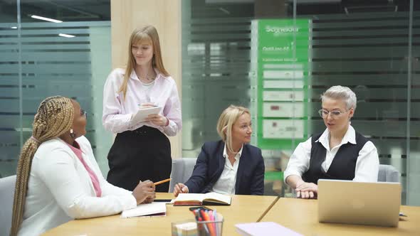 Group of a Young Business People Brainstorming and Discussing Business Plan in Office