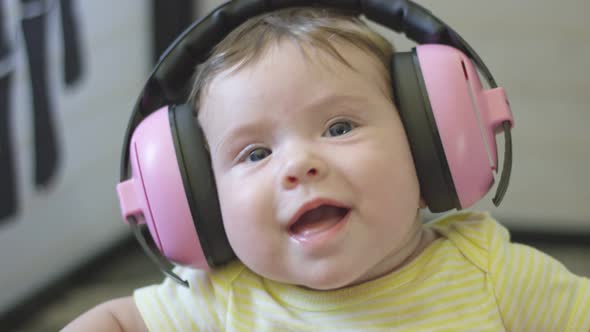 Slow Motion of Happy Baby Wearing Headphones