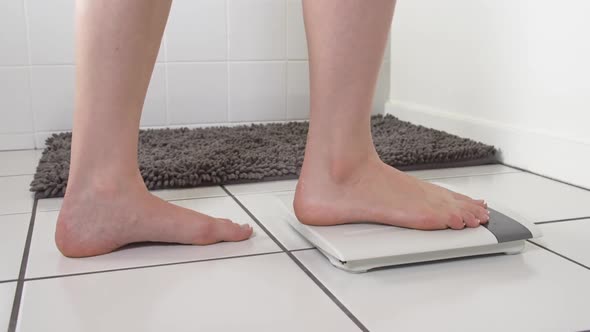 Woman Checking Weight Bathroom Scale