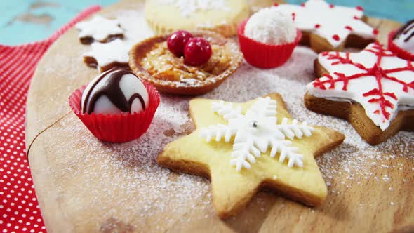 Christmas cookies with napkin on heart shape wooden board