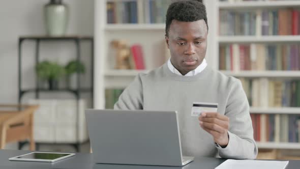 African Man Making Successful Online Payment on Laptop