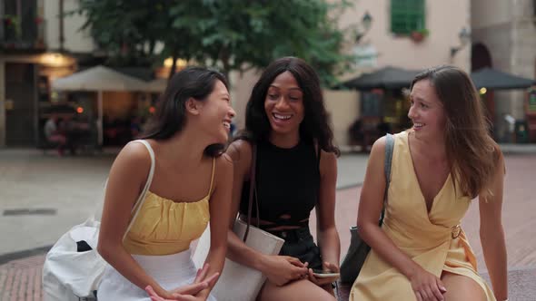 Three Happy Diverse Women Female Friends Chatting and Laughing While Spending Time Together Outdoor