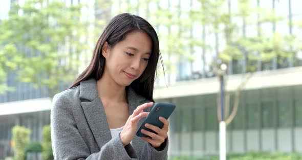 Woman use of smart phone in city