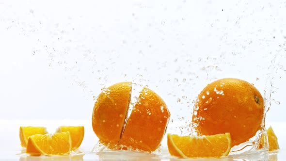 Fresh Oranges Dropped Into Water with Splash Shooted with High Speed Cinema Camera at 1000 Fps