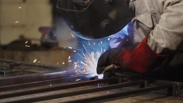 Close-up of Welder During Working with Metal Construction in a Factory Shop