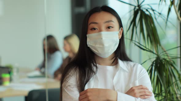 Portrait of Young Asian Businesswoman in Medical Mask