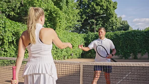 Tennis Players Shake Hands and Prepare to Start Competition